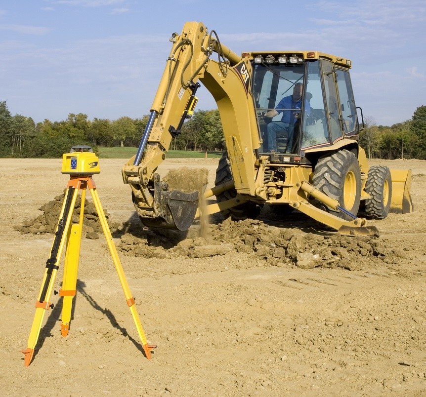 Spectra LR machine receiver on a backhoe dipper arm working to a rotary laser on a tripod