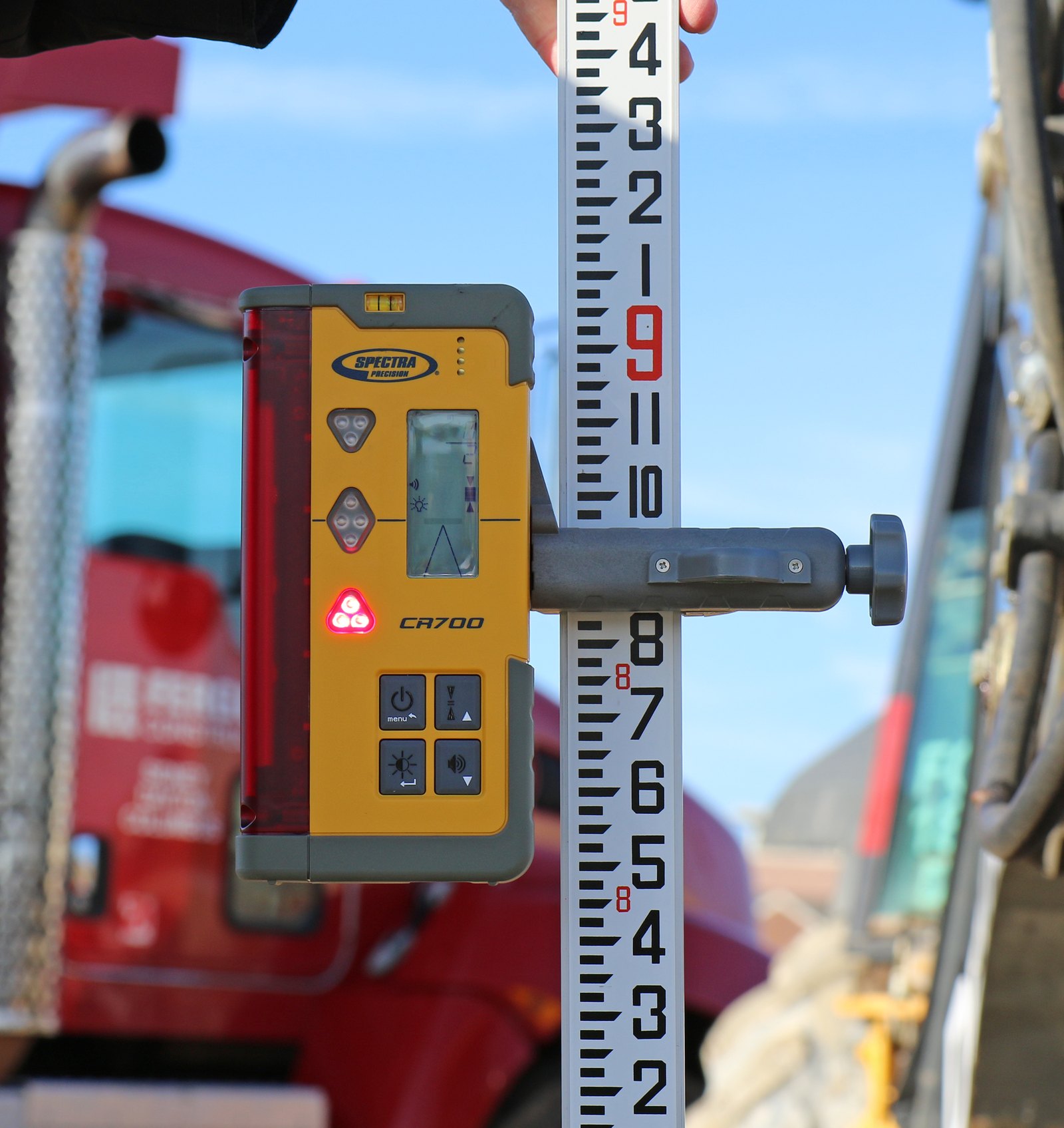 Spectra CR700 laser receiver clamped to a grade rod with the C70 clamp, showing a reading on the LCD